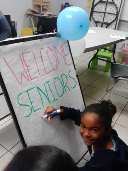 children making the sign for seniors