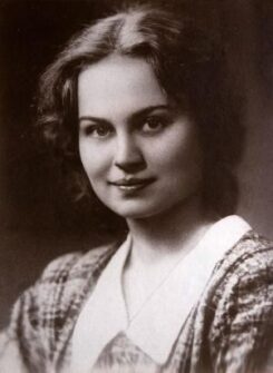 An older portrait of a young woman smiling.