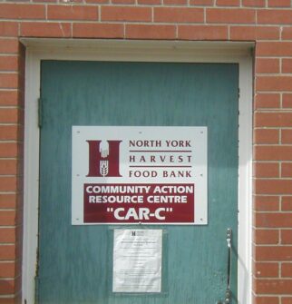A door with the North York Harvest Food Bank logo and text that reads "Community Action Resource Centre"