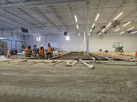 A warehouse under construction with crew members visible off to the left. This will be the new site of North York Harvest Food Bank's Community Food Hub in Toronto.