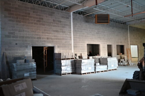 Construction materials line freshly built walls in a warehouse